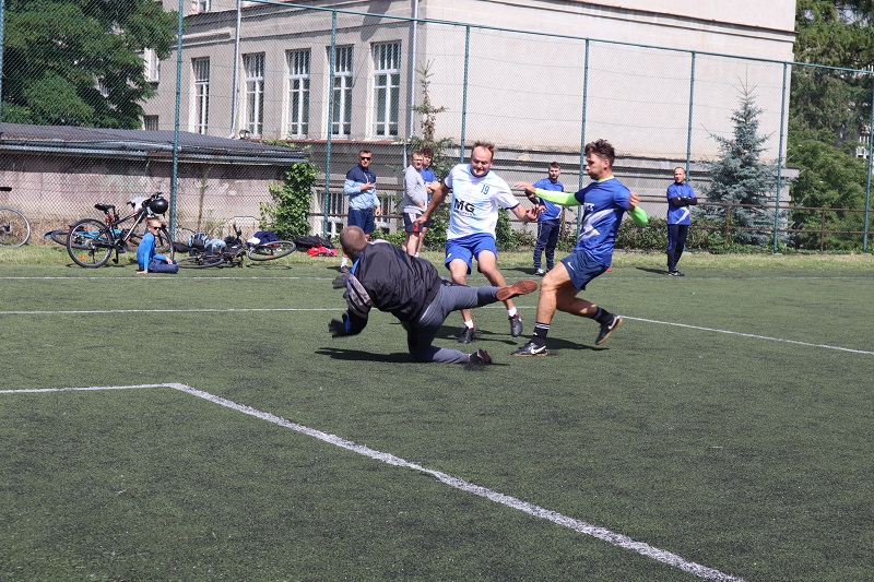 Bramkarz rzucający się pod nogi zawodnika z piłką.